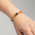 Monogram Icon V Cut-Out Bangle – Polished Gold Finish