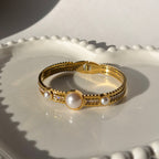 Gold bangle with big pearls and zircons